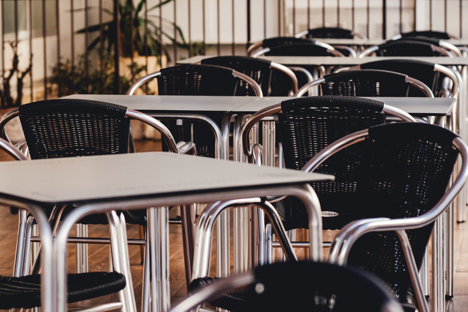Metal outdoor tables and chairs set outside a cafe